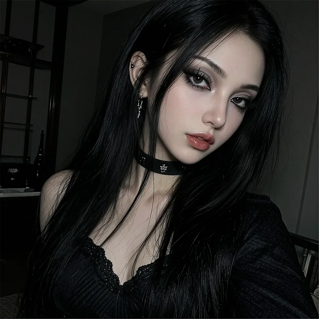 Woman with long black hair wearing black choker with cross pendant and dangle earrings in black knit v-neck top